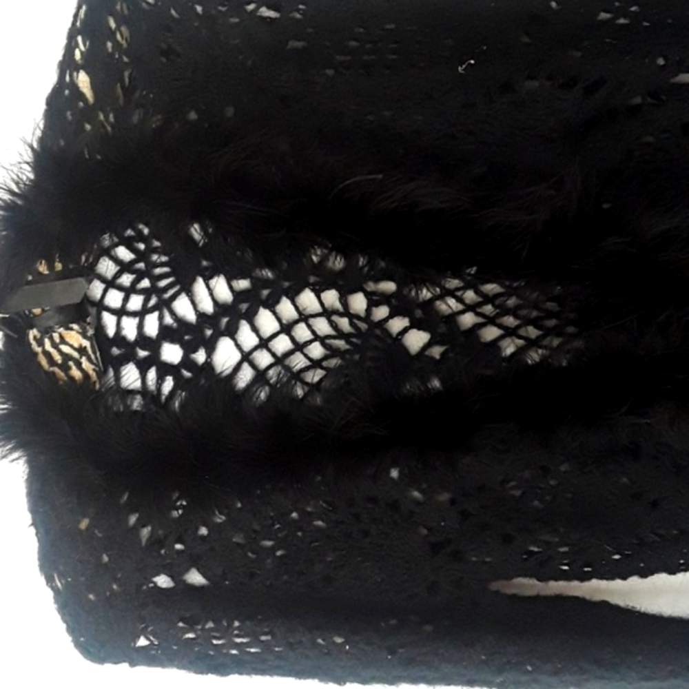 Long black cape with feather trim.